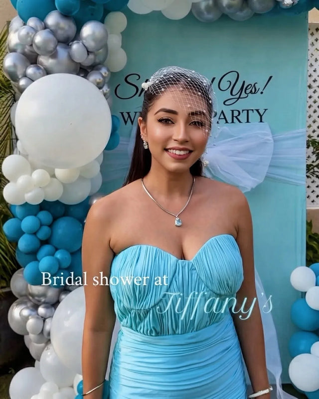 Woman wearing a white birdcage veil at her bridal shower