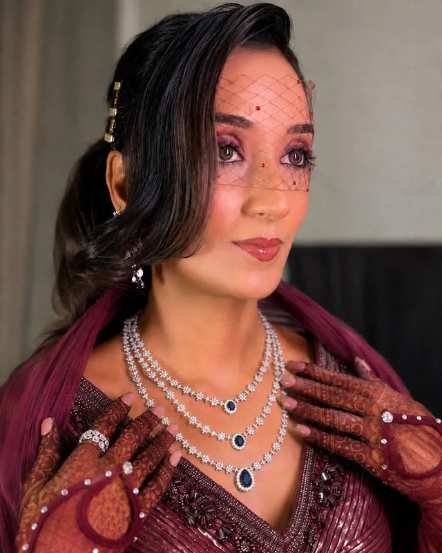 Woman wearing a face veil and embellished gloves for a masquerade look